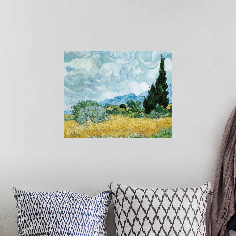 A bohemian room featuring Classic painting of a field with a tree and mountains in the distance and swirling clouds on canvas.