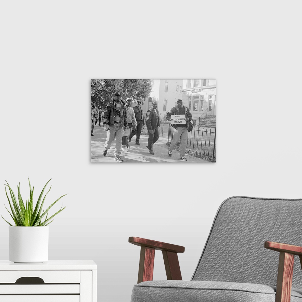 A modern room featuring African American men walking on Capitol Hill, during the Million Man March in Washington, D.C. Oc...