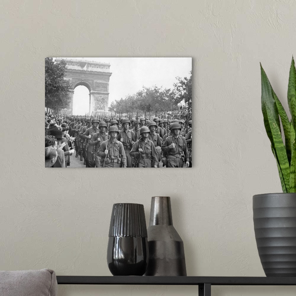 A modern room featuring American troops marched down the Champs Elysees to the cheers of Parisians. August 25, 1944, Worl...