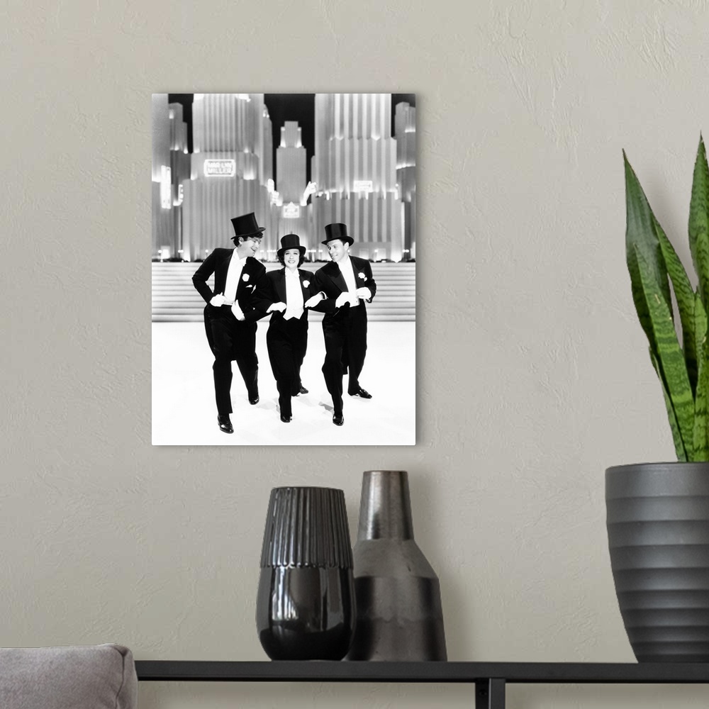 A modern room featuring Broadway Melody Of 1938, From Left: Buddy Ebsen, Eleanor Powell, George Murphy, 1937