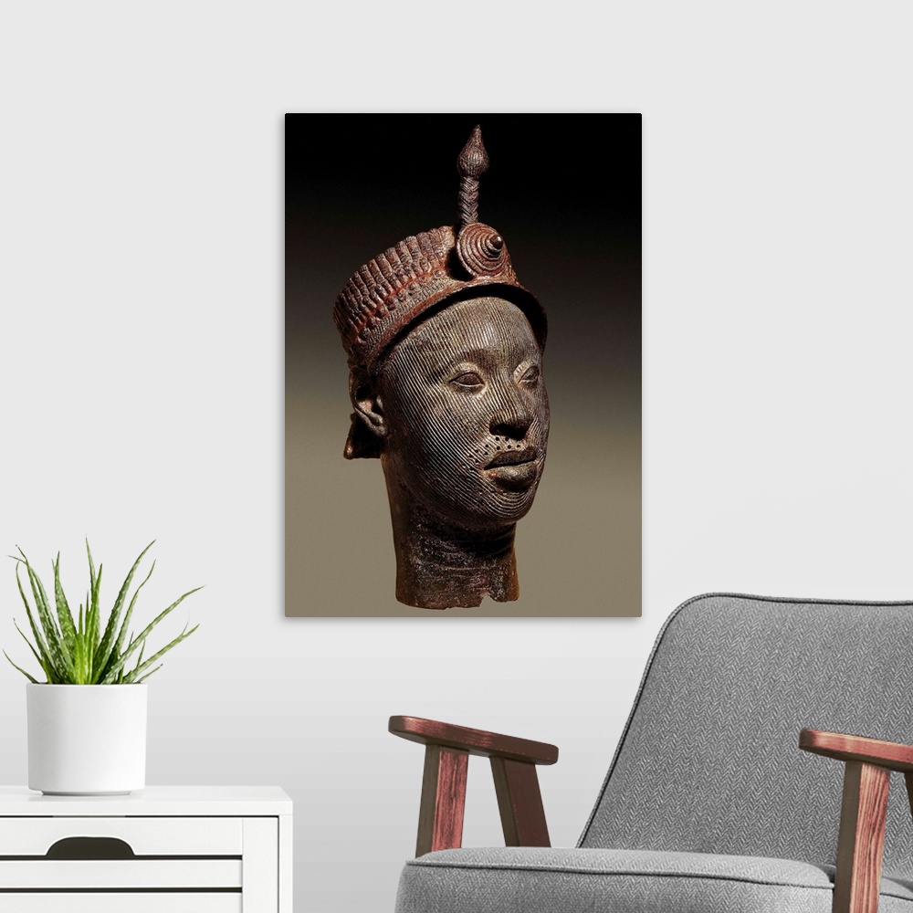 A modern room featuring Bronze head with beaded crown and plume, Yoruba art
