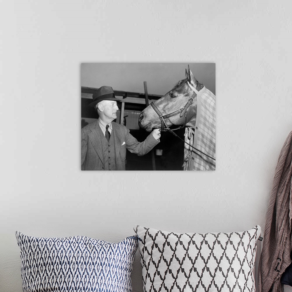 A bohemian room featuring Charles Howard admiring his horse Seabiscuit, March 5, 1940. Seabiscuit had just won the Santa An...