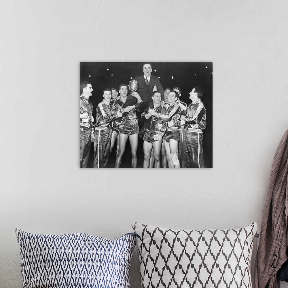 A bohemian room featuring Coach Adolph Rupp on the shoulders of Kentucky Wildcats basketball team. They had just won the Na...