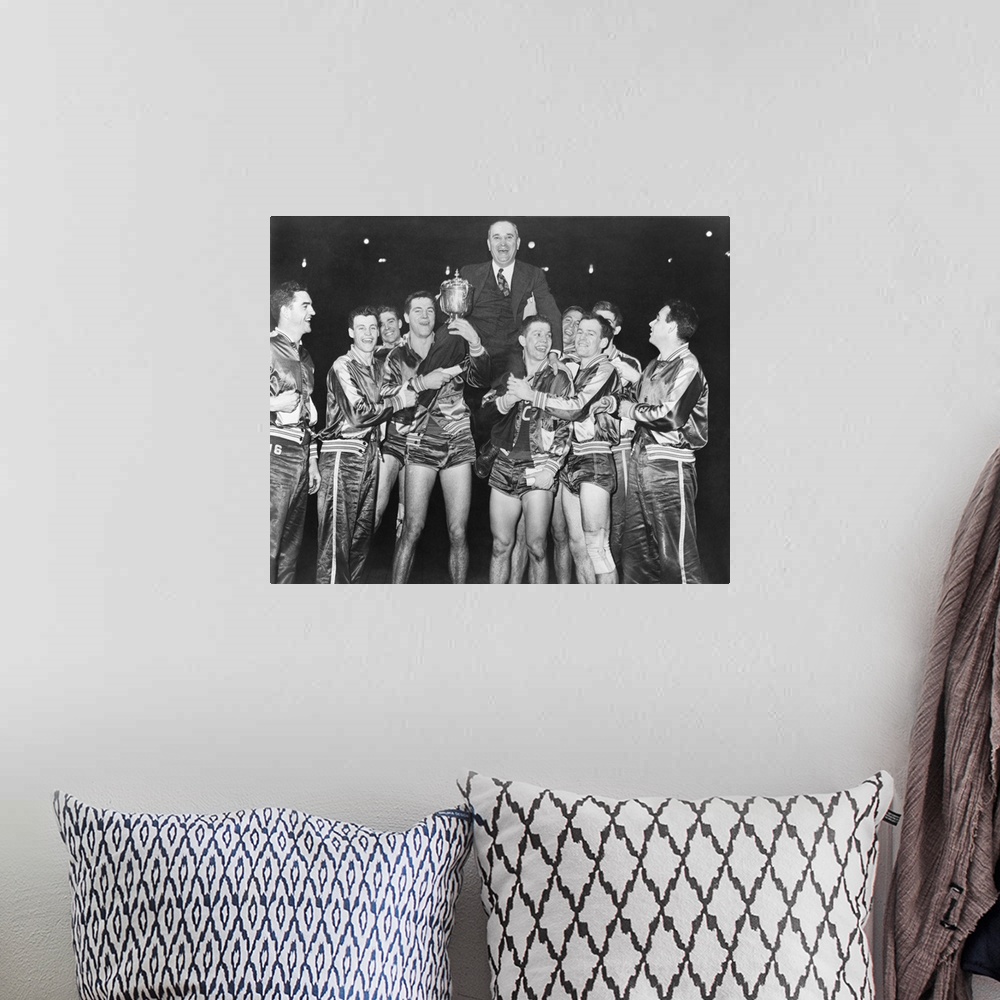 A bohemian room featuring Coach Adolph Rupp on the shoulders of Kentucky Wildcats basketball team. They had just won the Na...