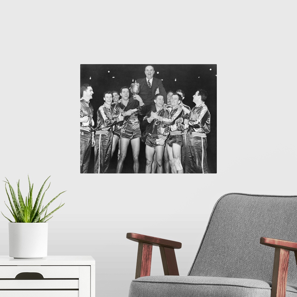 A modern room featuring Coach Adolph Rupp on the shoulders of Kentucky Wildcats basketball team. They had just won the Na...