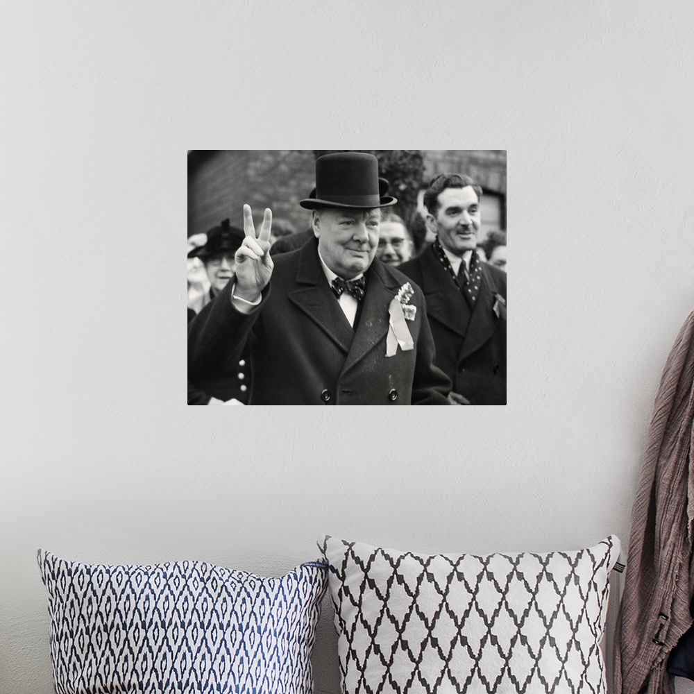 A bohemian room featuring Conservative Party Leader Winston Churchill gives his familiar victory sign. He was making a last...