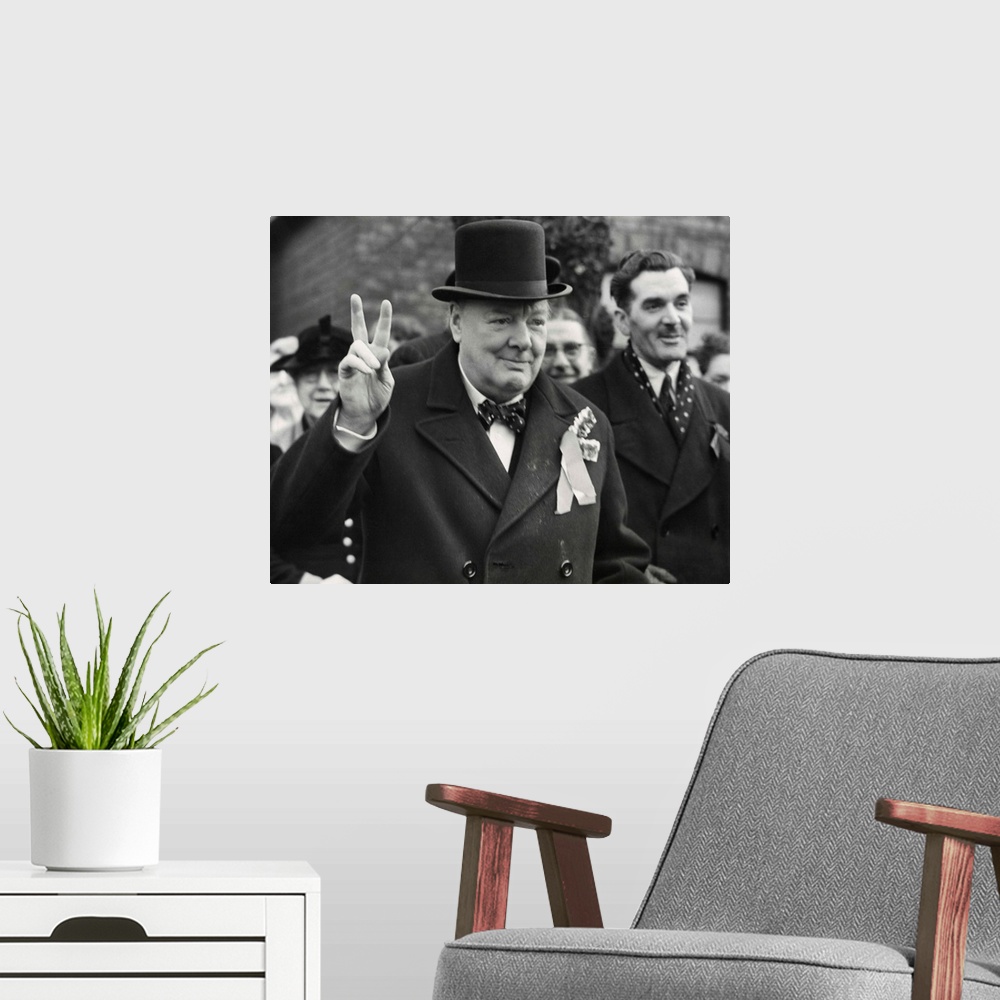 A modern room featuring Conservative Party Leader Winston Churchill gives his familiar victory sign. He was making a last...