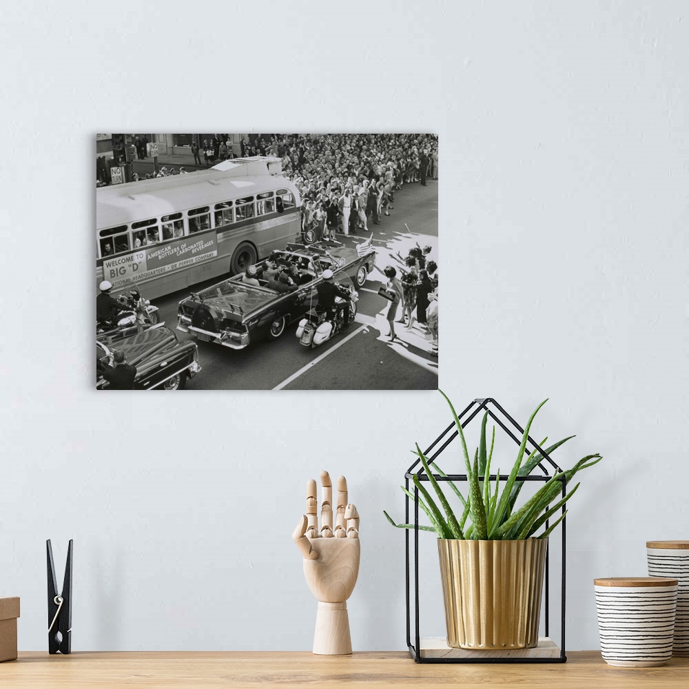 A bohemian room featuring Dallas crowds waving as President Kennedy's limousine drives through downtown Dallas. Texas Gover...