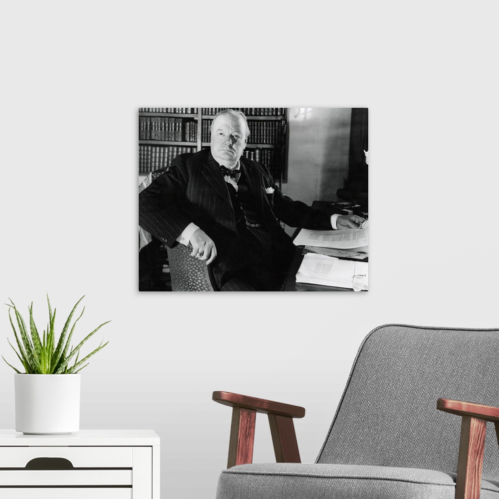 A modern room featuring Former Prime Minister Prime Winston Churchill, at his desk in Werterham, Kent. April 1948.