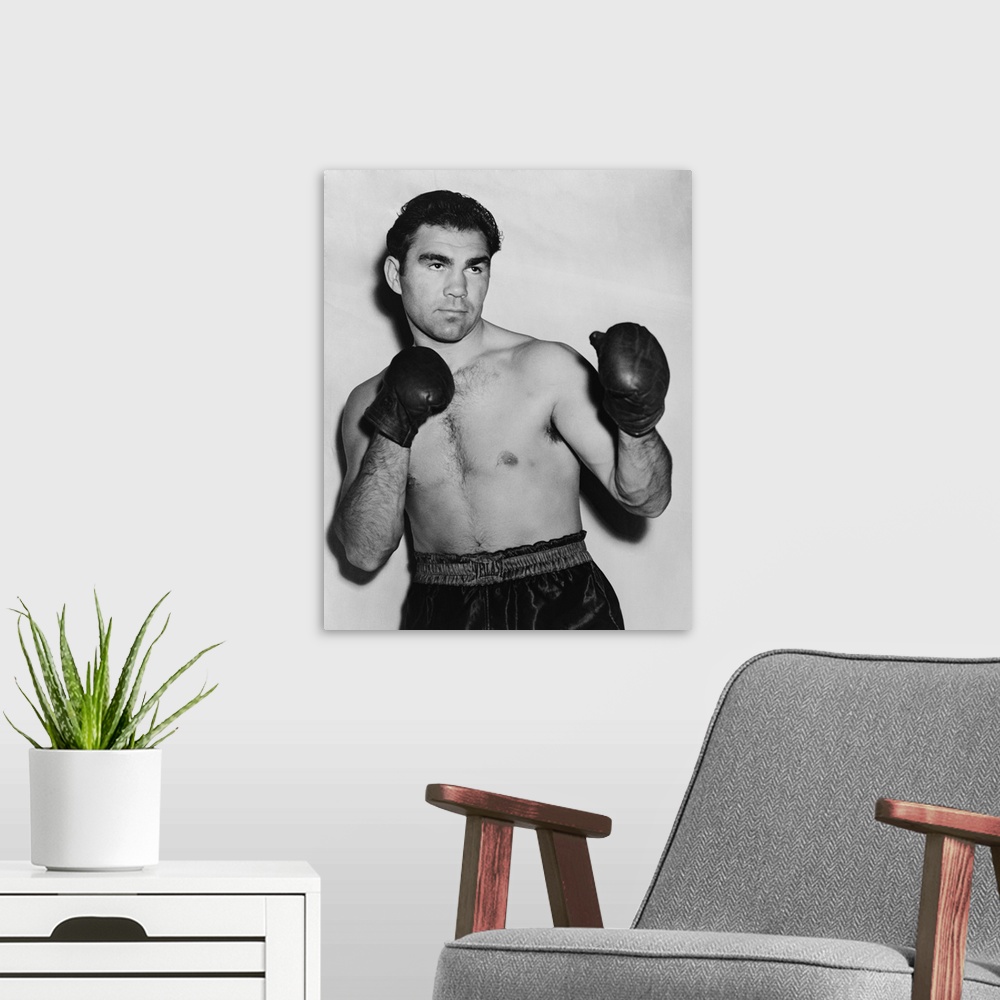 A modern room featuring German boxer Max Schmeling in a boxing pose in 1938. On June 22, 1938 he lost in a rematch with A...