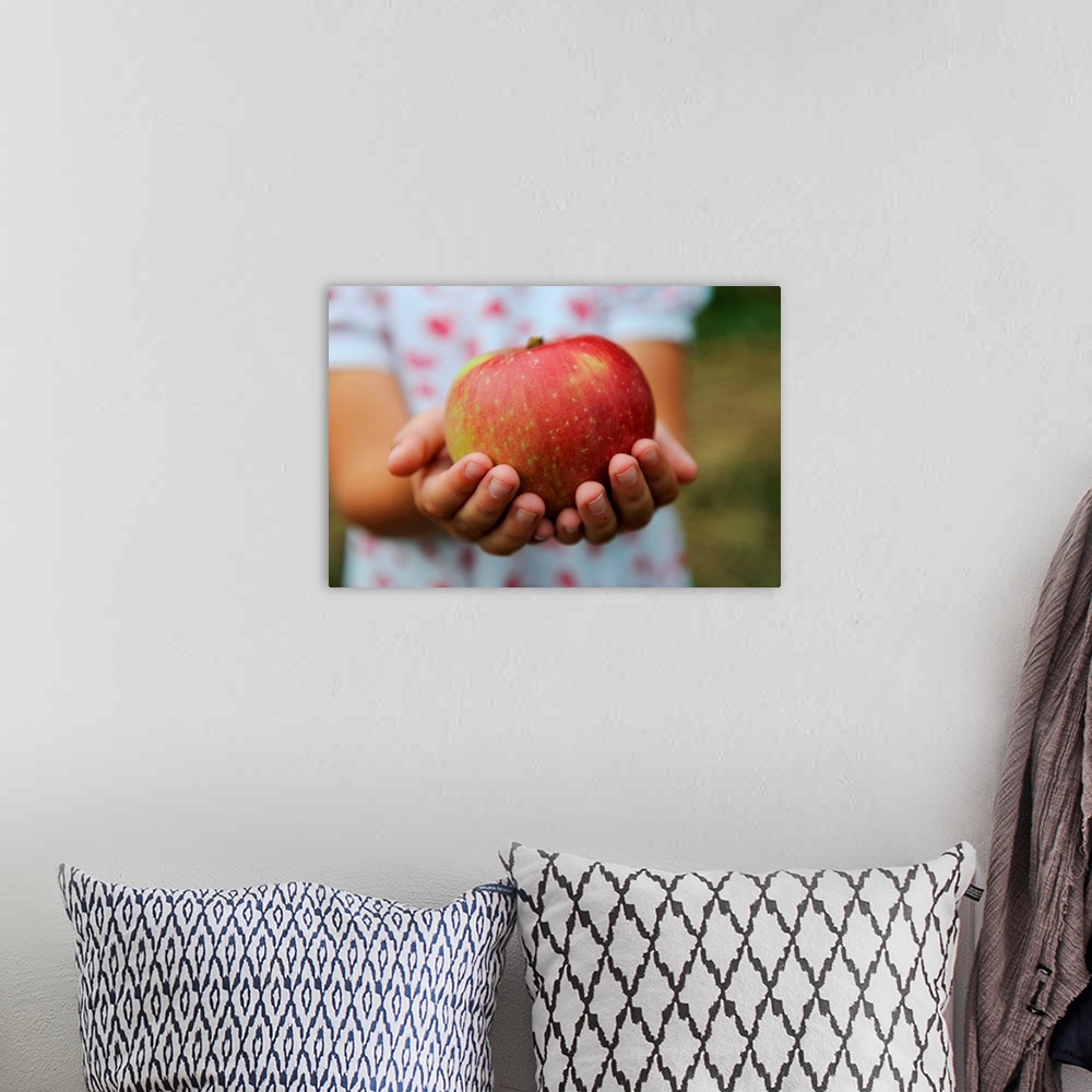 A bohemian room featuring Girl Holding Red Apple
