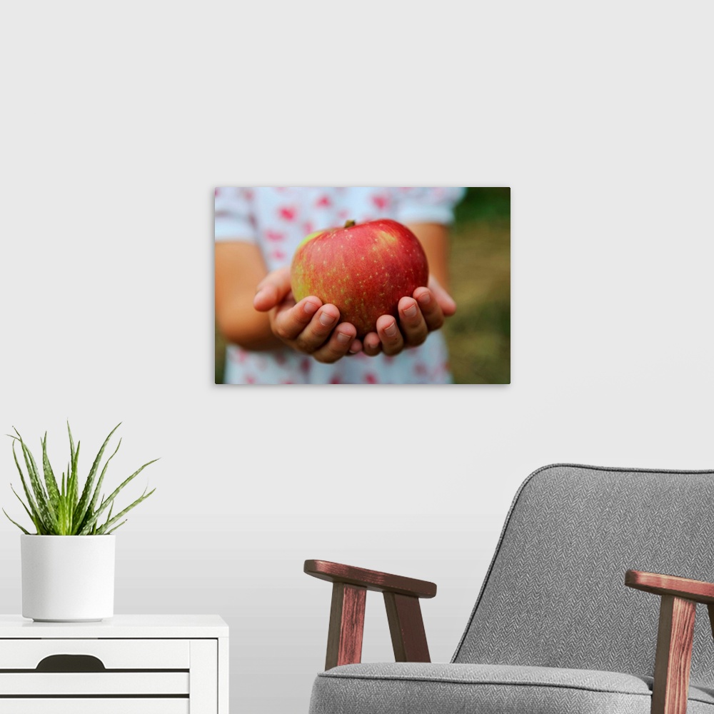 A modern room featuring Girl Holding Red Apple