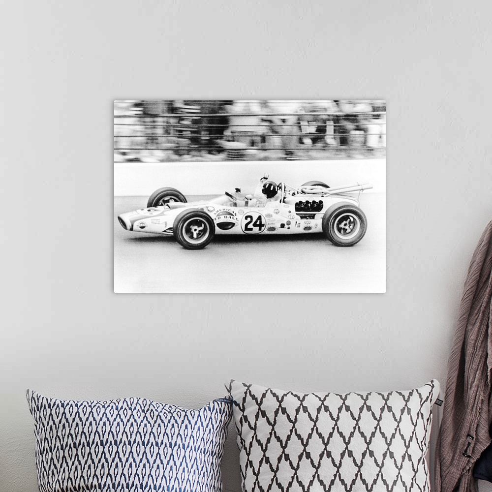 A bohemian room featuring Graham Hill, waves as his car streaks toward the finish line to win the Indianapolis 500. May 30,...