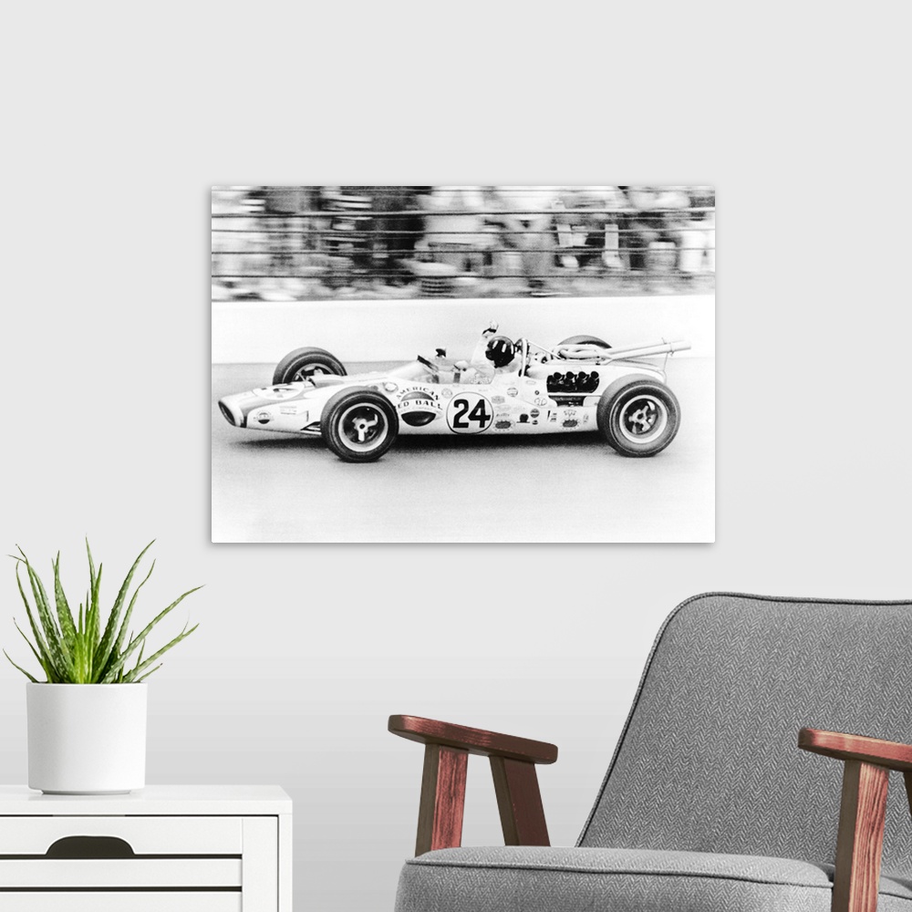 A modern room featuring Graham Hill, waves as his car streaks toward the finish line to win the Indianapolis 500. May 30,...