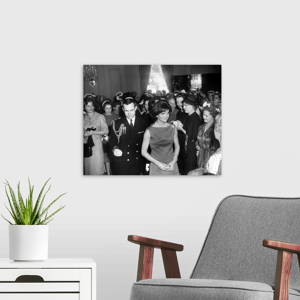 A modern room featuring Jacqueline Kennedy at a reception for the wives of American Society of Newspaper Editors. April 1...