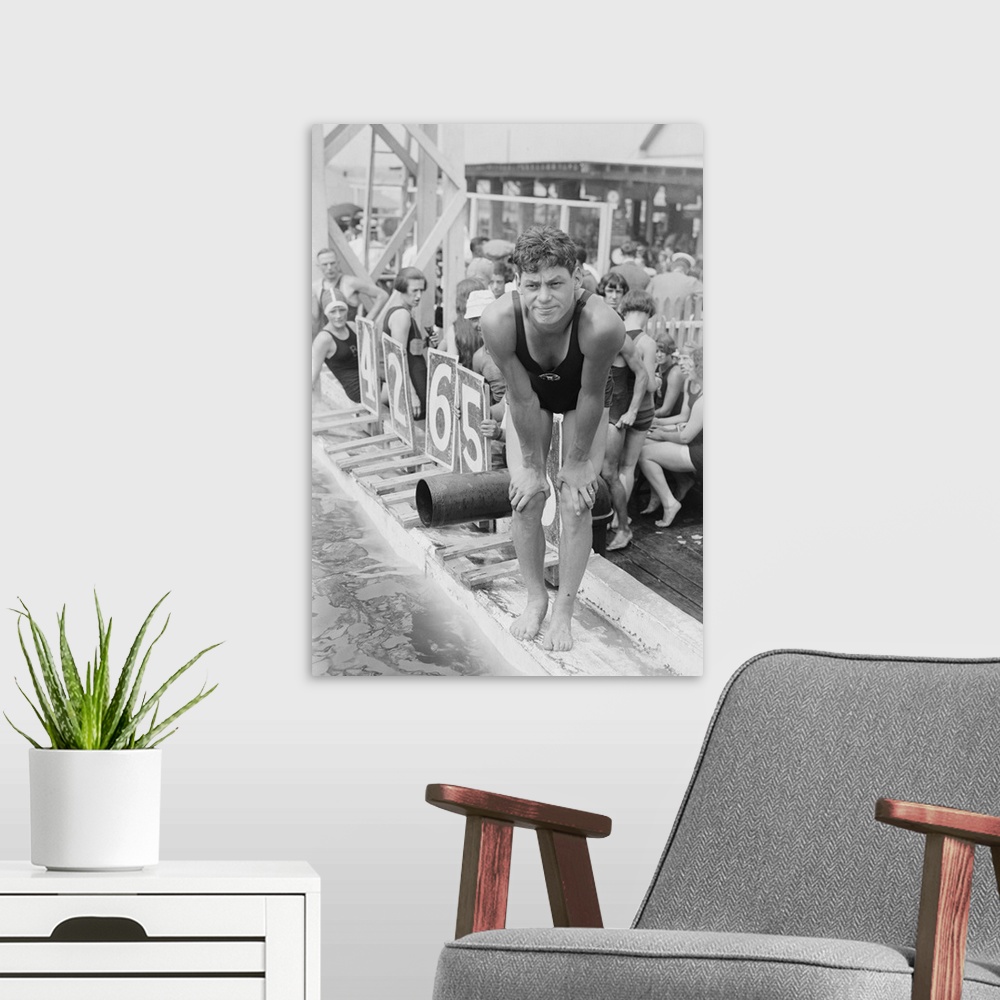 A modern room featuring Johnny Weissmuller at competitive swimming event in the 1920s. After winning five Olympic gold me...