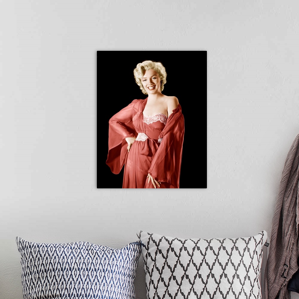 A bohemian room featuring Vintage publicity photograph of Marilyn Monroe, wearing a red robe and dress.