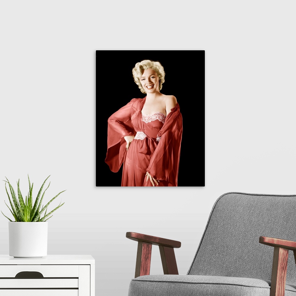 A modern room featuring Vintage publicity photograph of Marilyn Monroe, wearing a red robe and dress.