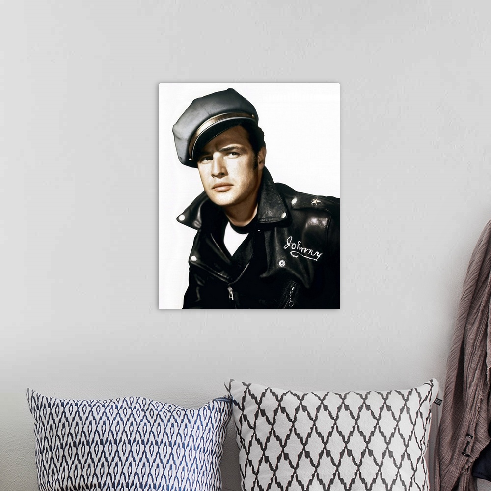 A bohemian room featuring A vintage photograph of Marlon Brando wearing a leather jacket and cap, to promote his movie "The...