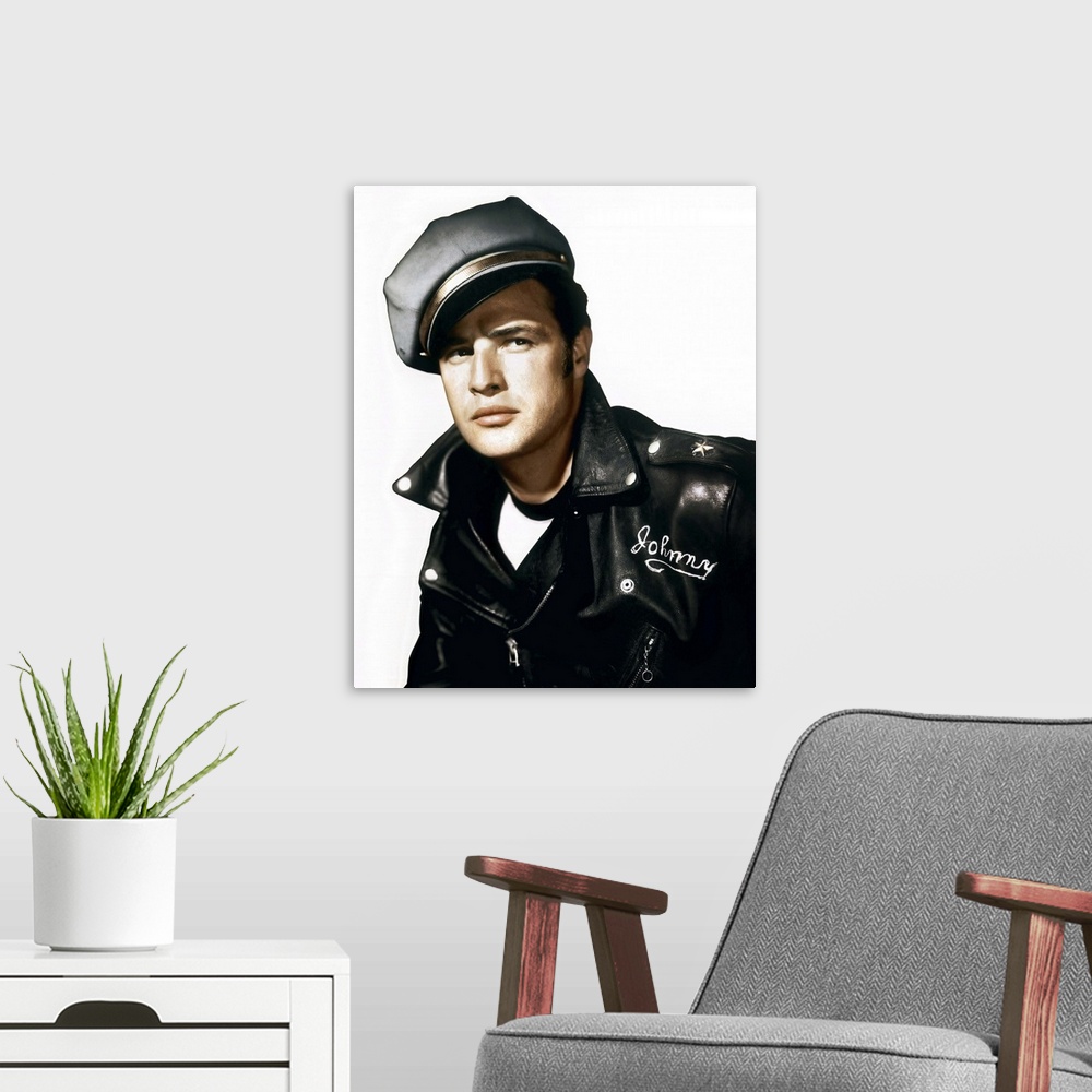 A modern room featuring A vintage photograph of Marlon Brando wearing a leather jacket and cap, to promote his movie "The...