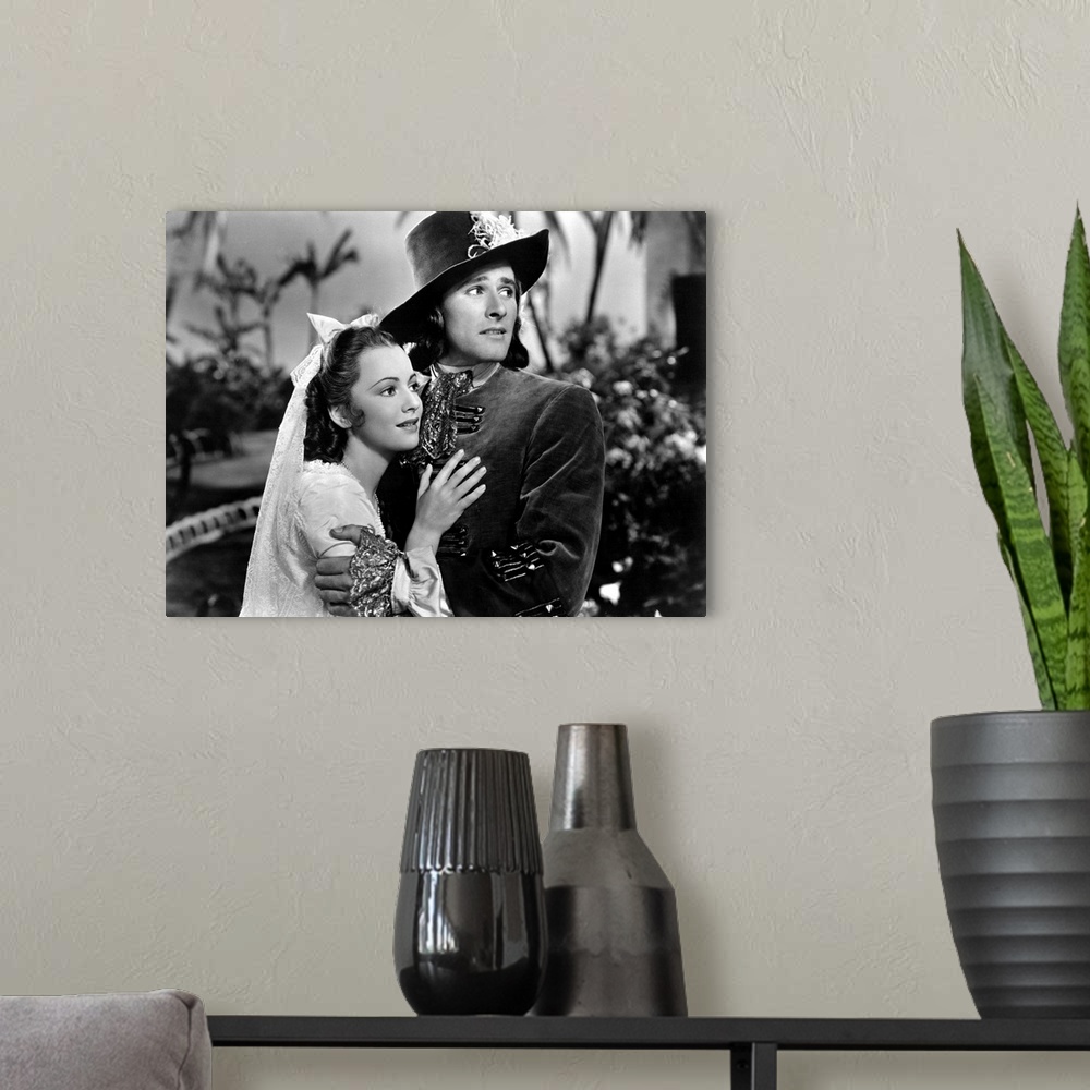 A modern room featuring Olivia de Havilland and Errol Flynn in Captain Blood - Movie Still