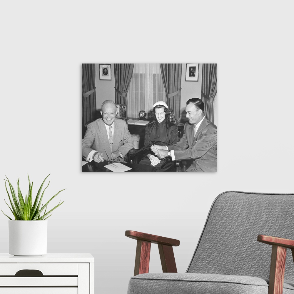 A modern room featuring President Eisenhower with Champion Golfer Ben Hogan and his wife in the Oval Office. Aug. 8, 1953