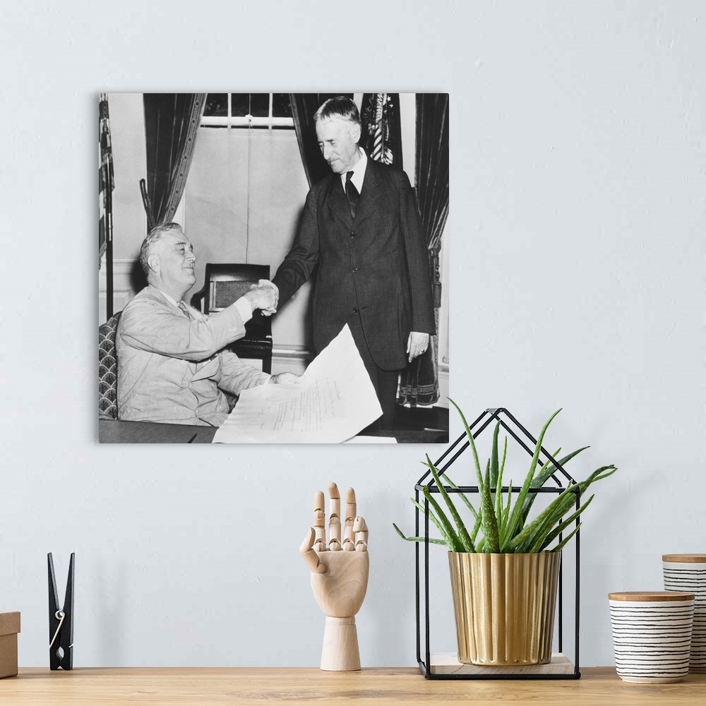 A bohemian room featuring President Franklin Roosevelt shaking hands with his new Secretary of War, Republican Henry Stimso...