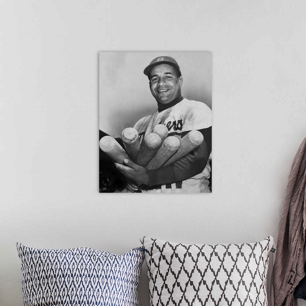 A bohemian room featuring Roy Campanella, catcher for the Brooklyn Dodgers, holding six bats, June 4, 1953. He was one of t...