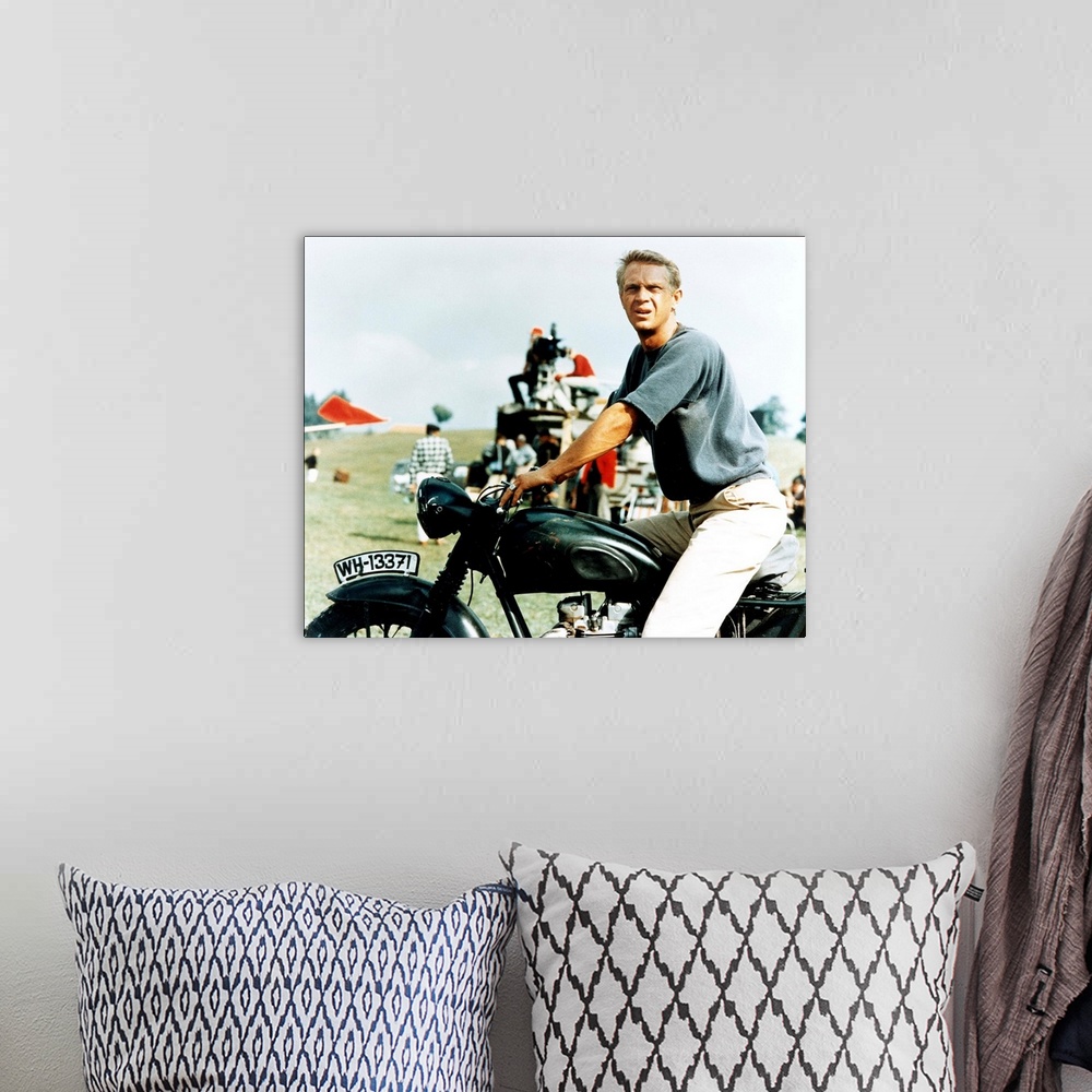 A bohemian room featuring Steve McQueen with motorcycle on the set of GREAT ESCAPE, 1963.