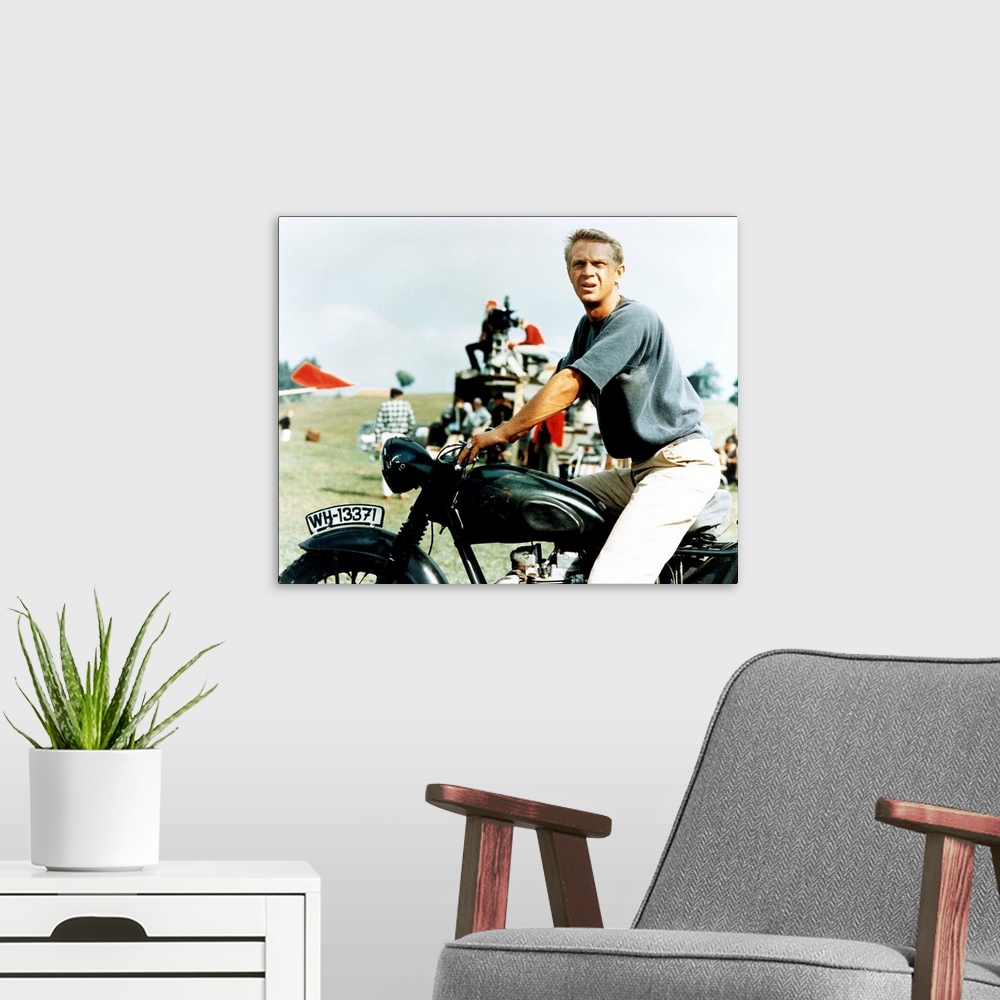 A modern room featuring Steve McQueen with motorcycle on the set of GREAT ESCAPE, 1963.