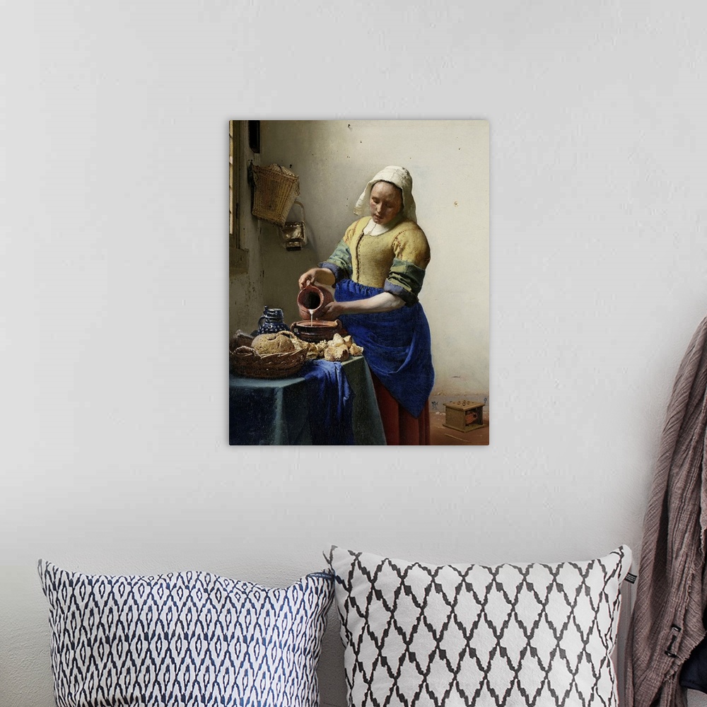 A bohemian room featuring The Milkmaid, by Johannes Vermeer, 1660, Dutch painting, oil on canvas. Illuminated by light from...