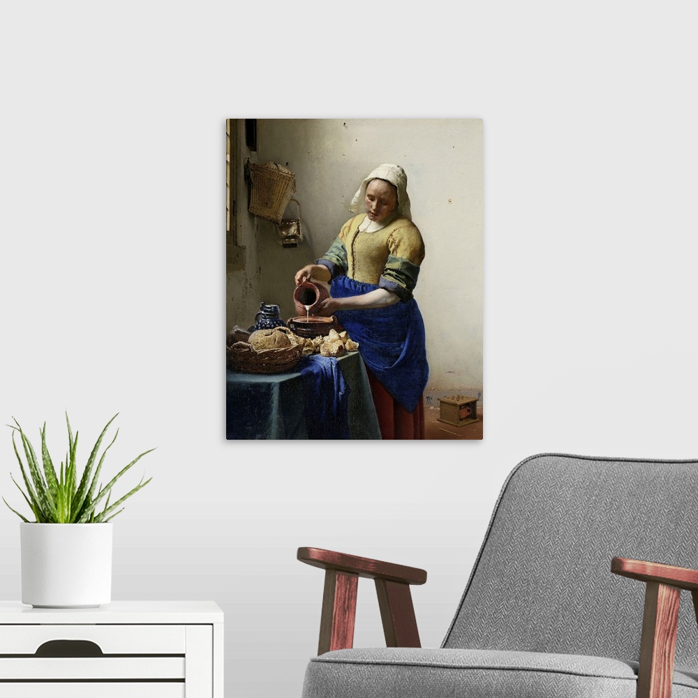 A modern room featuring The Milkmaid, by Johannes Vermeer, 1660, Dutch painting, oil on canvas. Illuminated by light from...