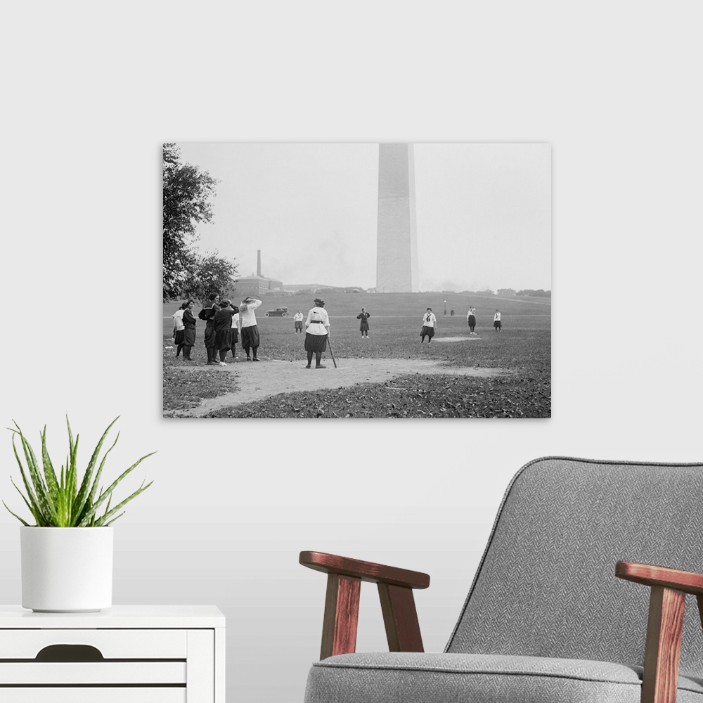 A modern room featuring Young women in bloomers and middy shirts playing baseball on the National Mall. Oct 19, 1919. Was...