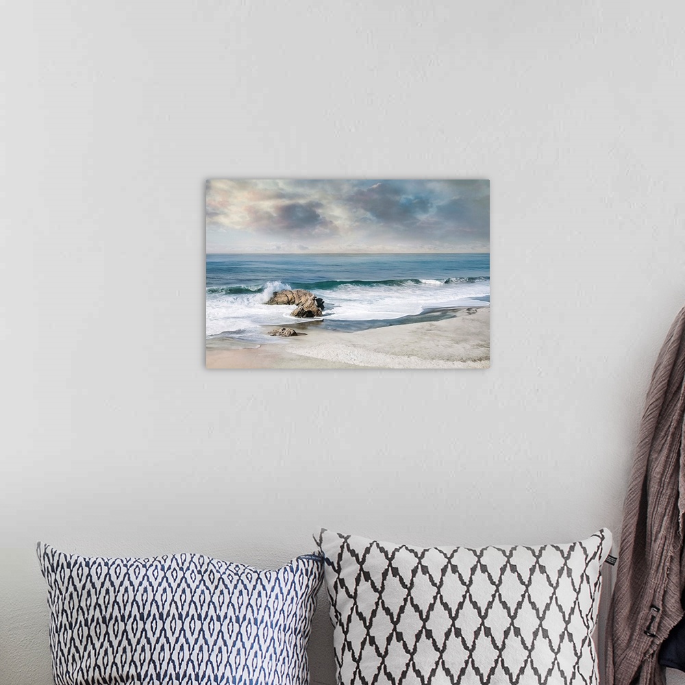 A bohemian room featuring Landscape photograph of waves crashing onto a rock on the sandy shore.