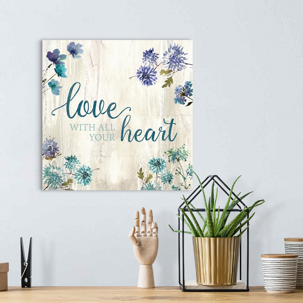 A bohemian room featuring Decorative watercolor artwork of a group of flowers with the text "Love With All your Heart".