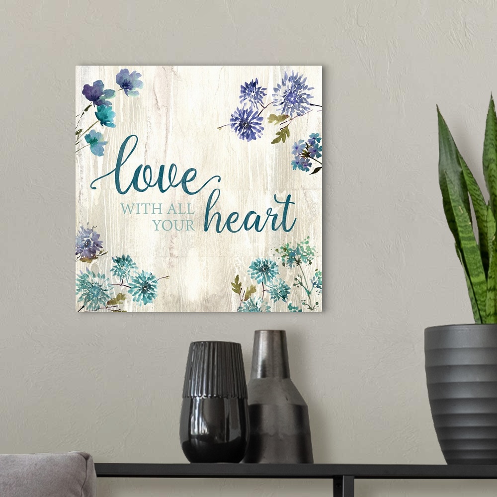 A modern room featuring Decorative watercolor artwork of a group of flowers with the text "Love With All your Heart".