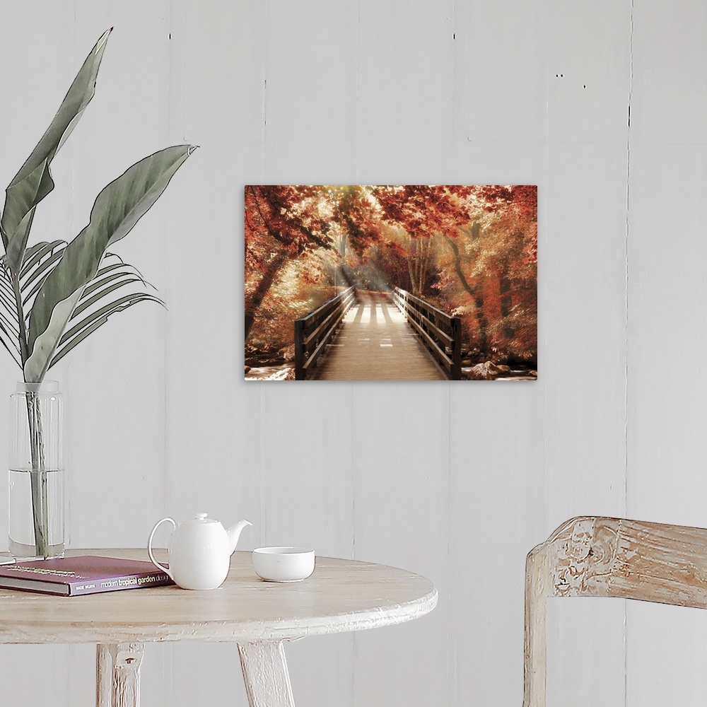 A farmhouse room featuring Photograph of a bridge going over a creek in woods covered in red Fall trees with beautiful sunli...