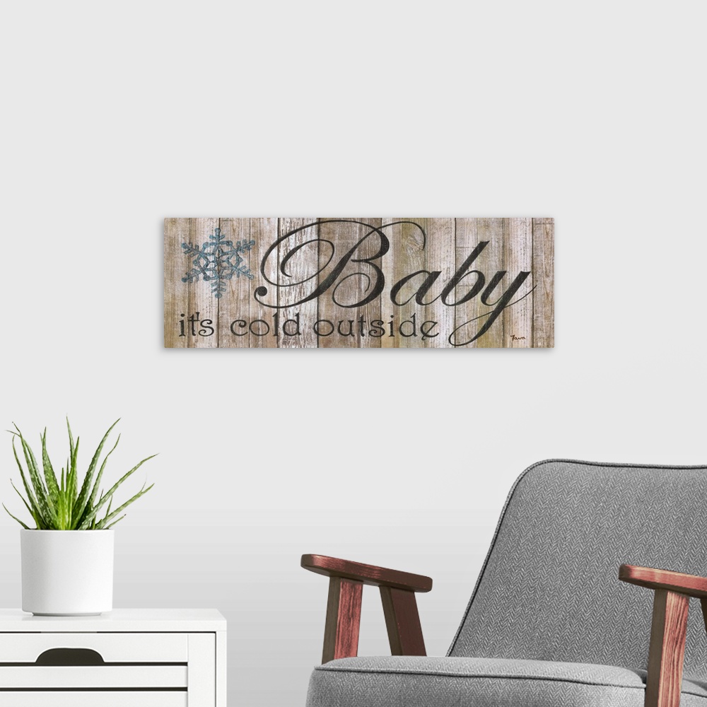 A modern room featuring A decorative winter painting of a blue snowflake and the phrase ?Baby it?s cold outside? painted ...