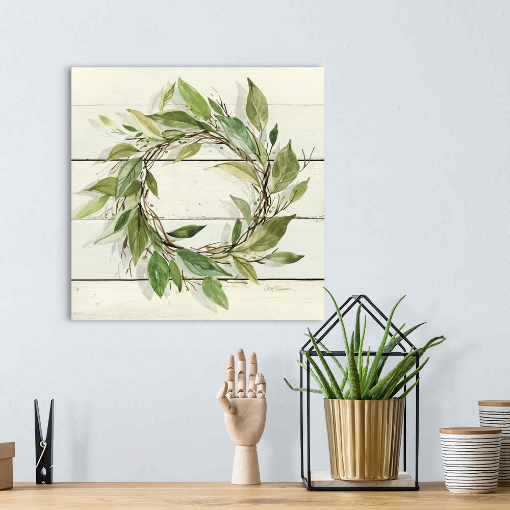 A bohemian room featuring A watercolor painting of a wreath with green leaves on a wood background.