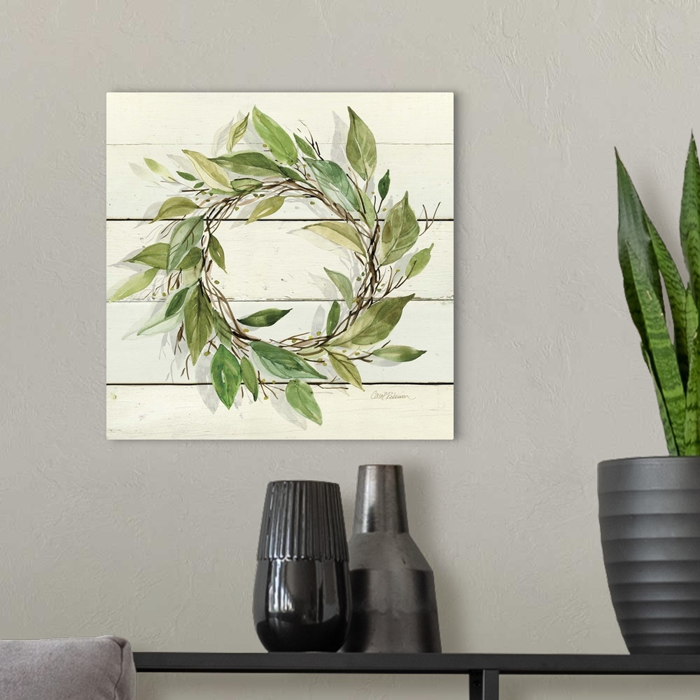 A modern room featuring A watercolor painting of a wreath with green leaves on a wood background.