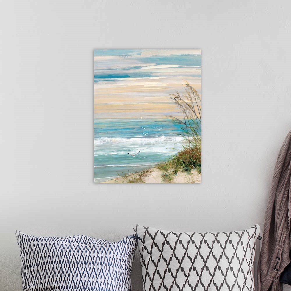 A bohemian room featuring Contemporary painting of a beach scene with crashing ocean waves, beach grass blowing in the wind...