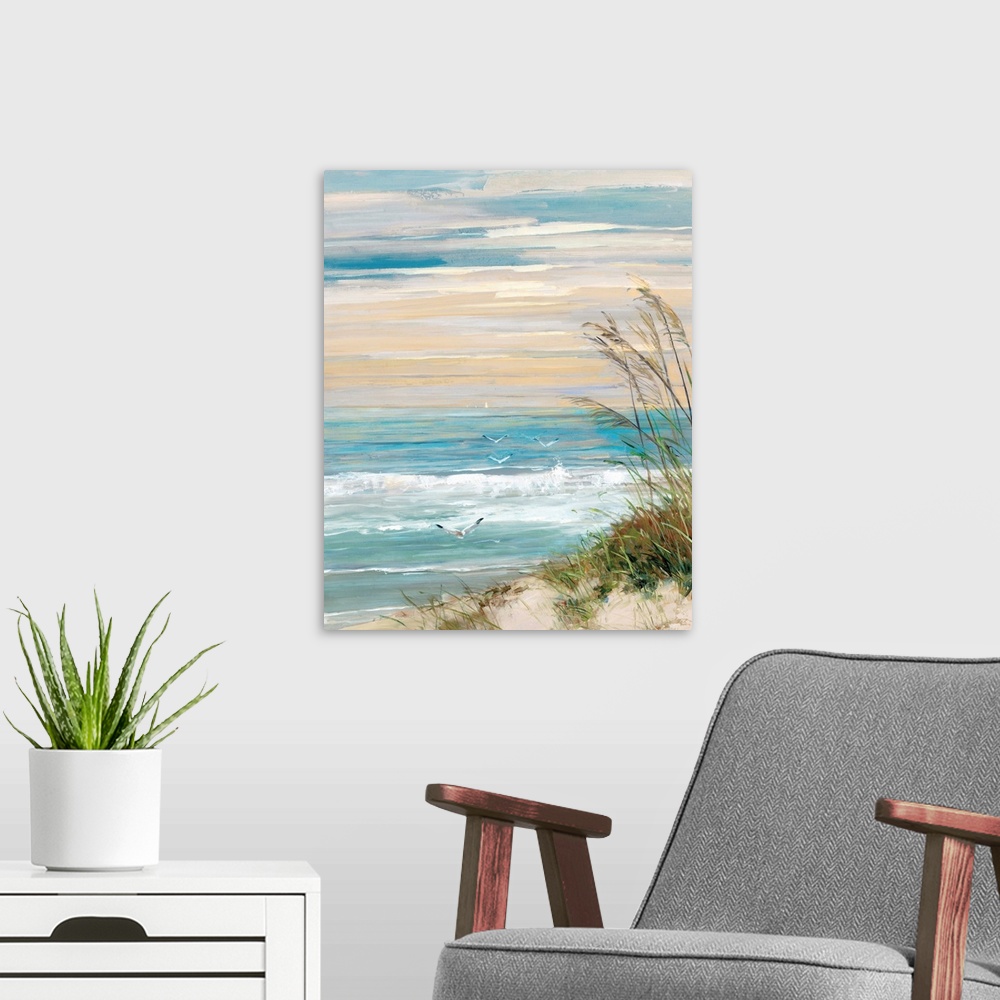 A modern room featuring Contemporary painting of a beach scene with crashing ocean waves, beach grass blowing in the wind...