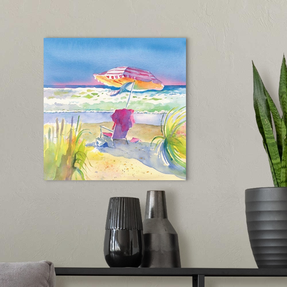 A modern room featuring Square watercolor painting of chair and umbrella on the beach in vibrant, warm colors.