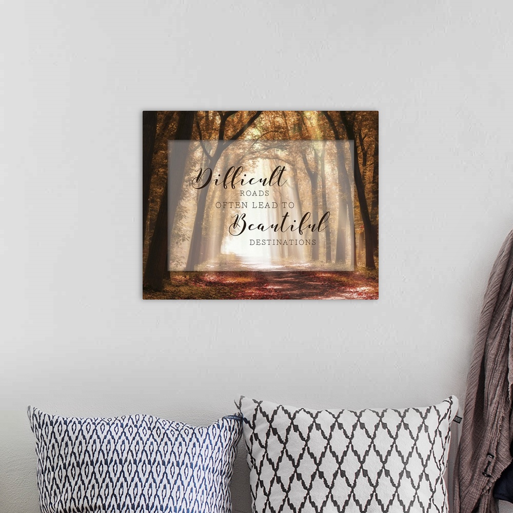 A bohemian room featuring A photograph of a pathway in the autumn woods with an inspirational quote overlay.