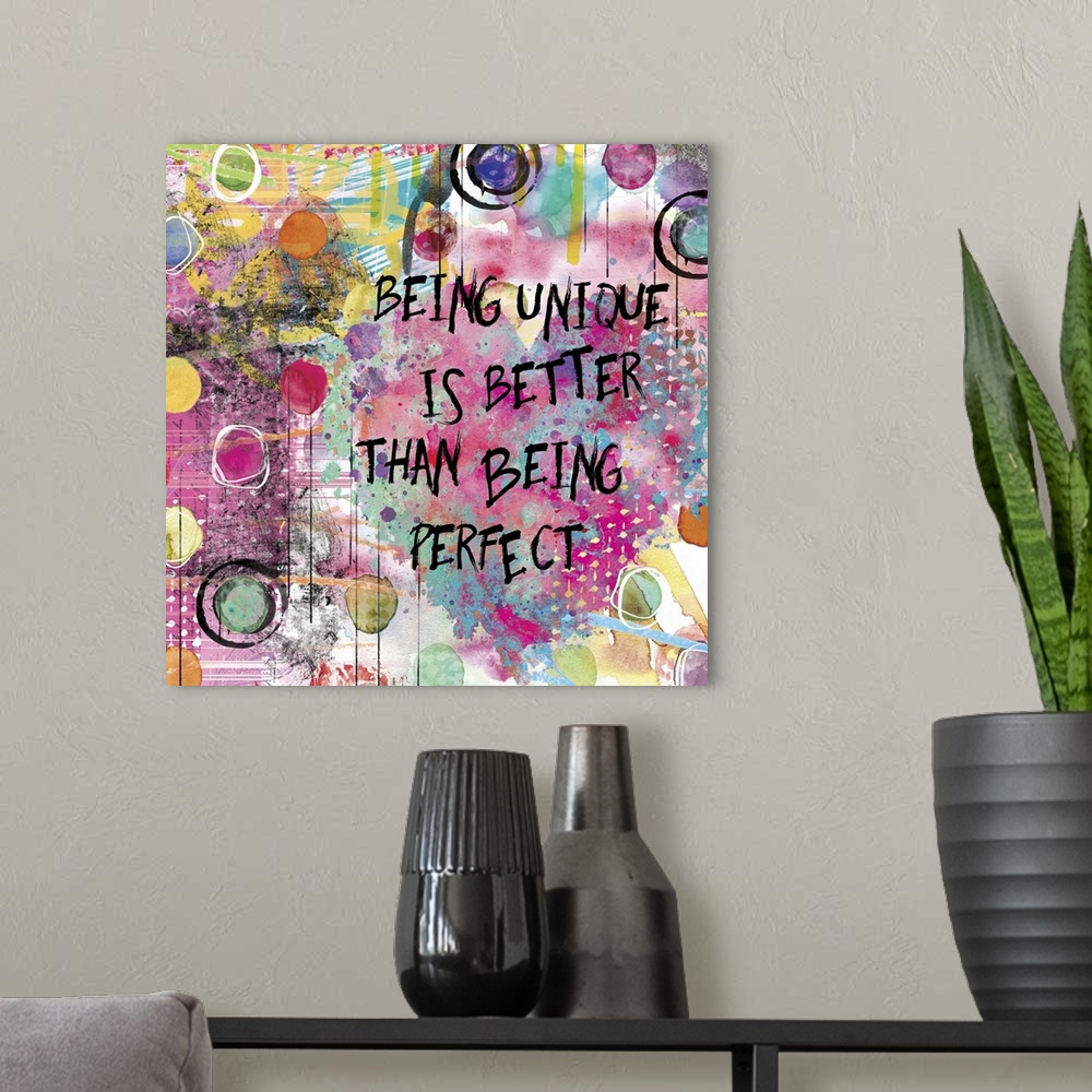 A modern room featuring Inspirational square painting with colorful designs, circles, and a large heart with the phrase "...