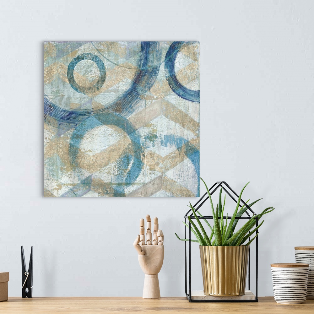 A bohemian room featuring Abstract painting that has big blue circular outlines with hints of gold on a textured background.