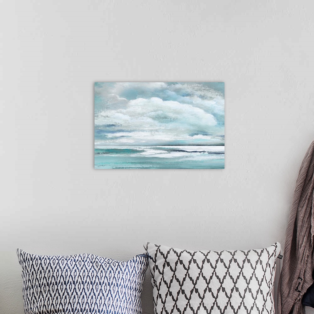 A bohemian room featuring Cool toned landscape painting of fluffy clouds over the ocean.