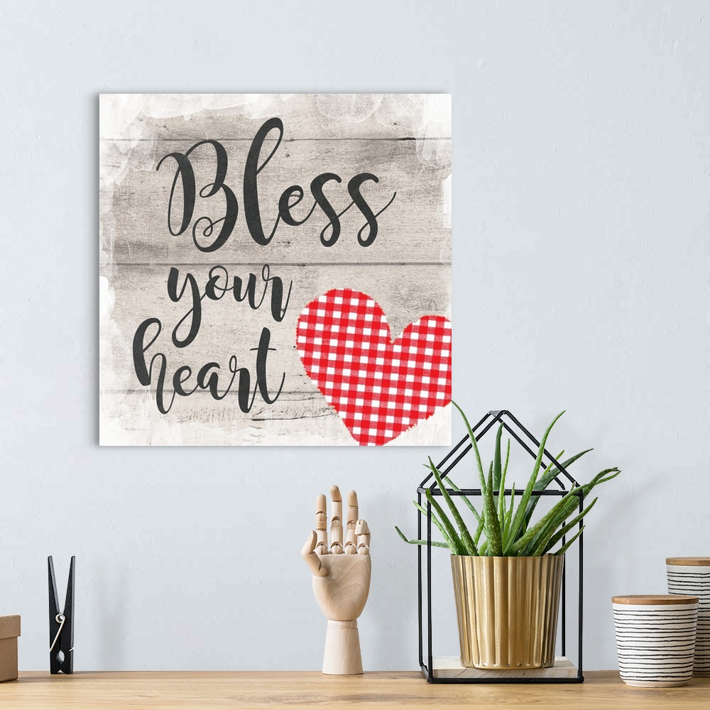 A bohemian room featuring "Bless Your Heart" placed on a gray wood texture with a plaid heart in the bottom right corner.