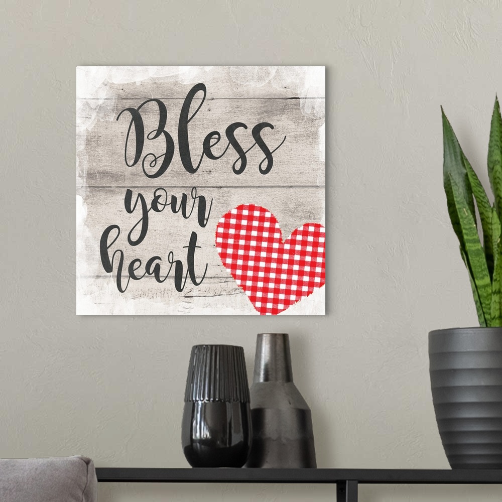 A modern room featuring "Bless Your Heart" placed on a gray wood texture with a plaid heart in the bottom right corner.