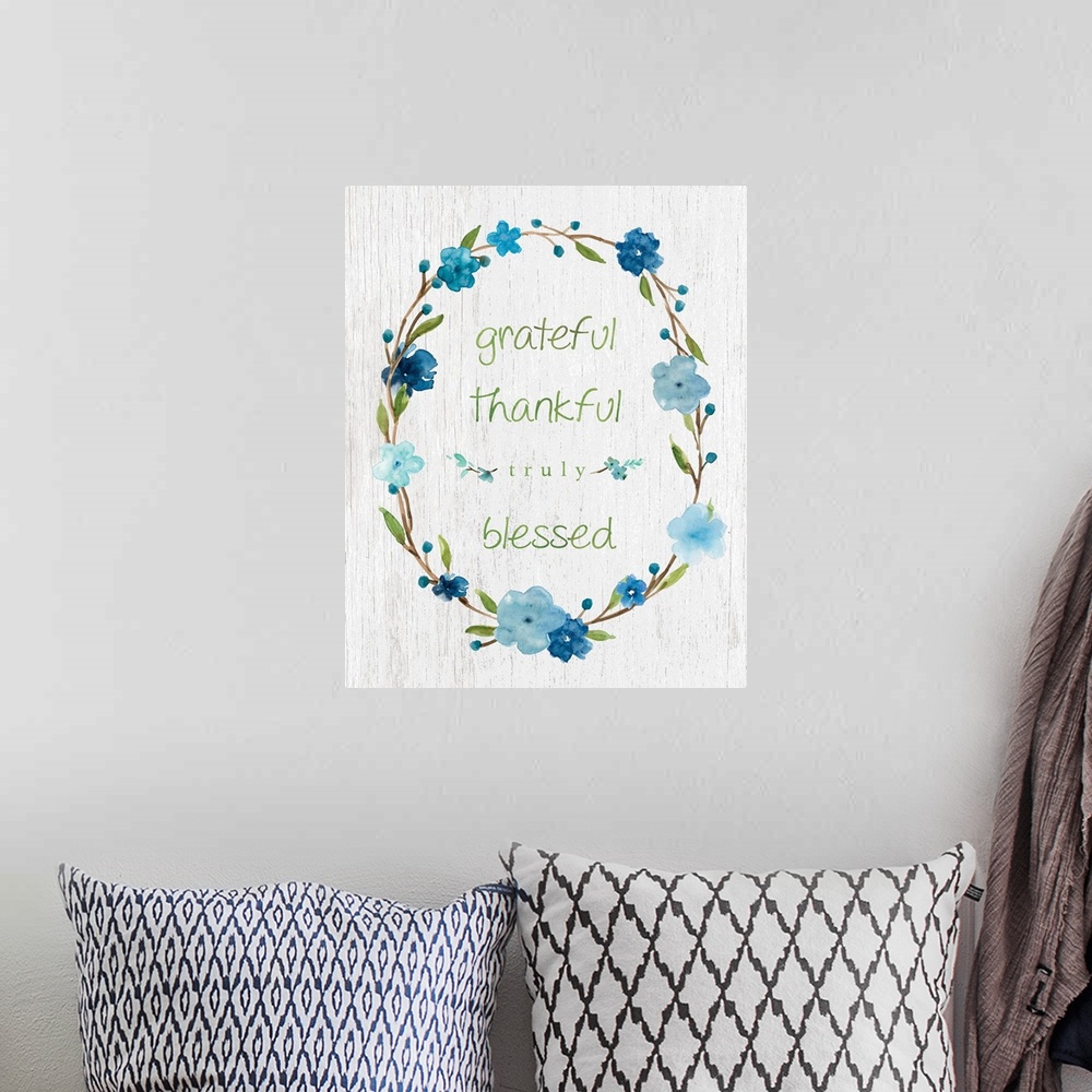 A bohemian room featuring "Grateful, Thankful, Truly Blessed" placed on a white textured background with blue flowers surro...